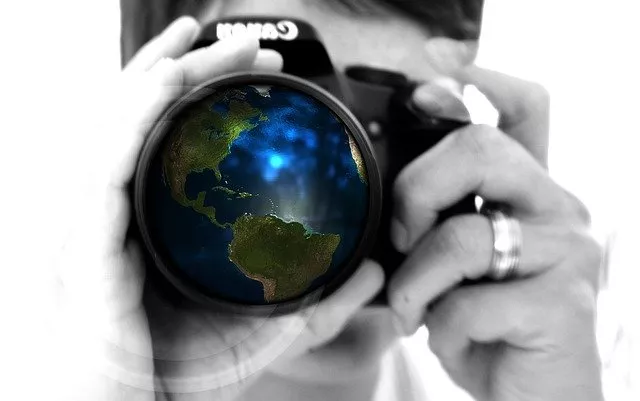 Person holding a camera that has North and South America in the lens view